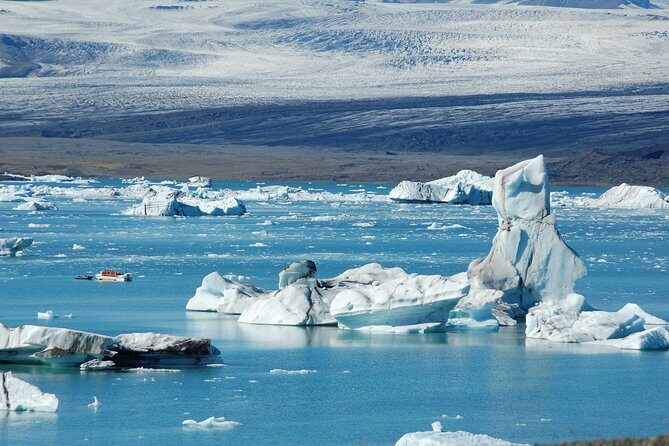 Guided Glacier Lagoon and Diamond Beach Day Trip from Reykjavik - Skógafoss: 60 meters of misty drama and photo-friendly rainbows